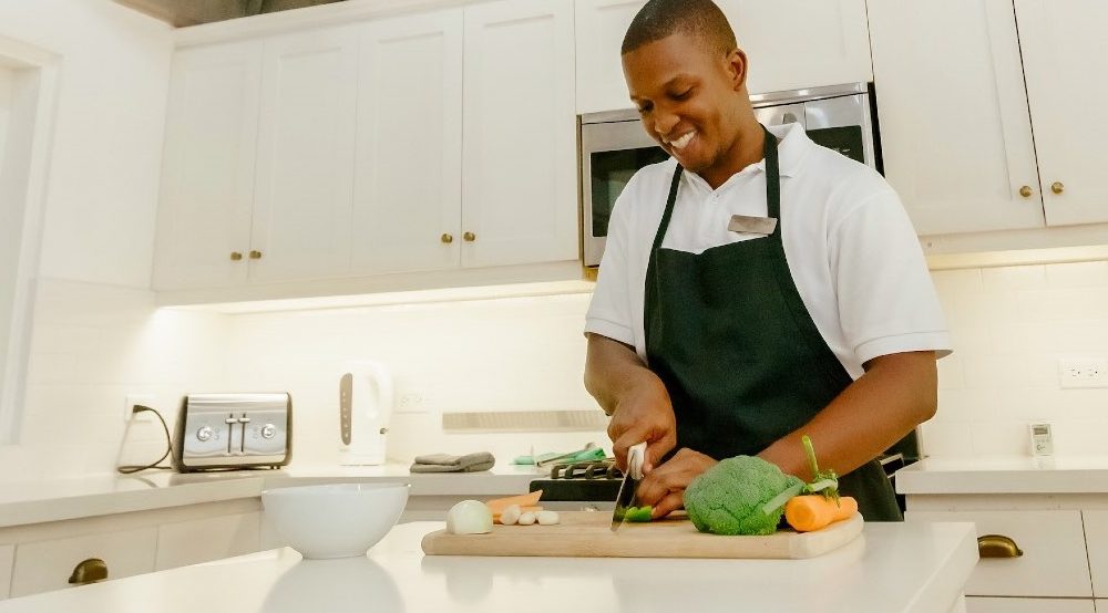 Private chef preparing fresh vegetables in the kitchen at Coconut Cottage villa Montego Bay Jamaica