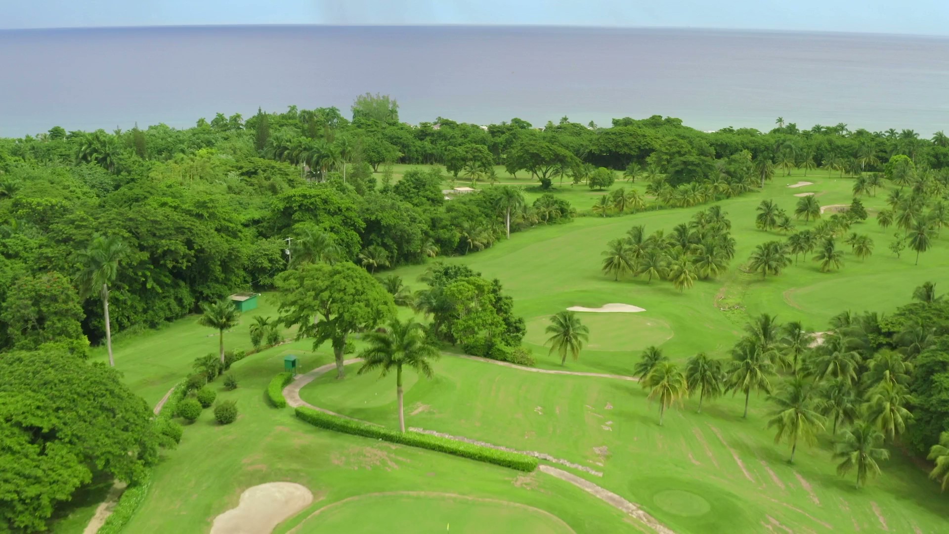 Tryall club. Aerial view of Tryall's lush tropical golf course in Montego Bay with palm trees and ocean views.