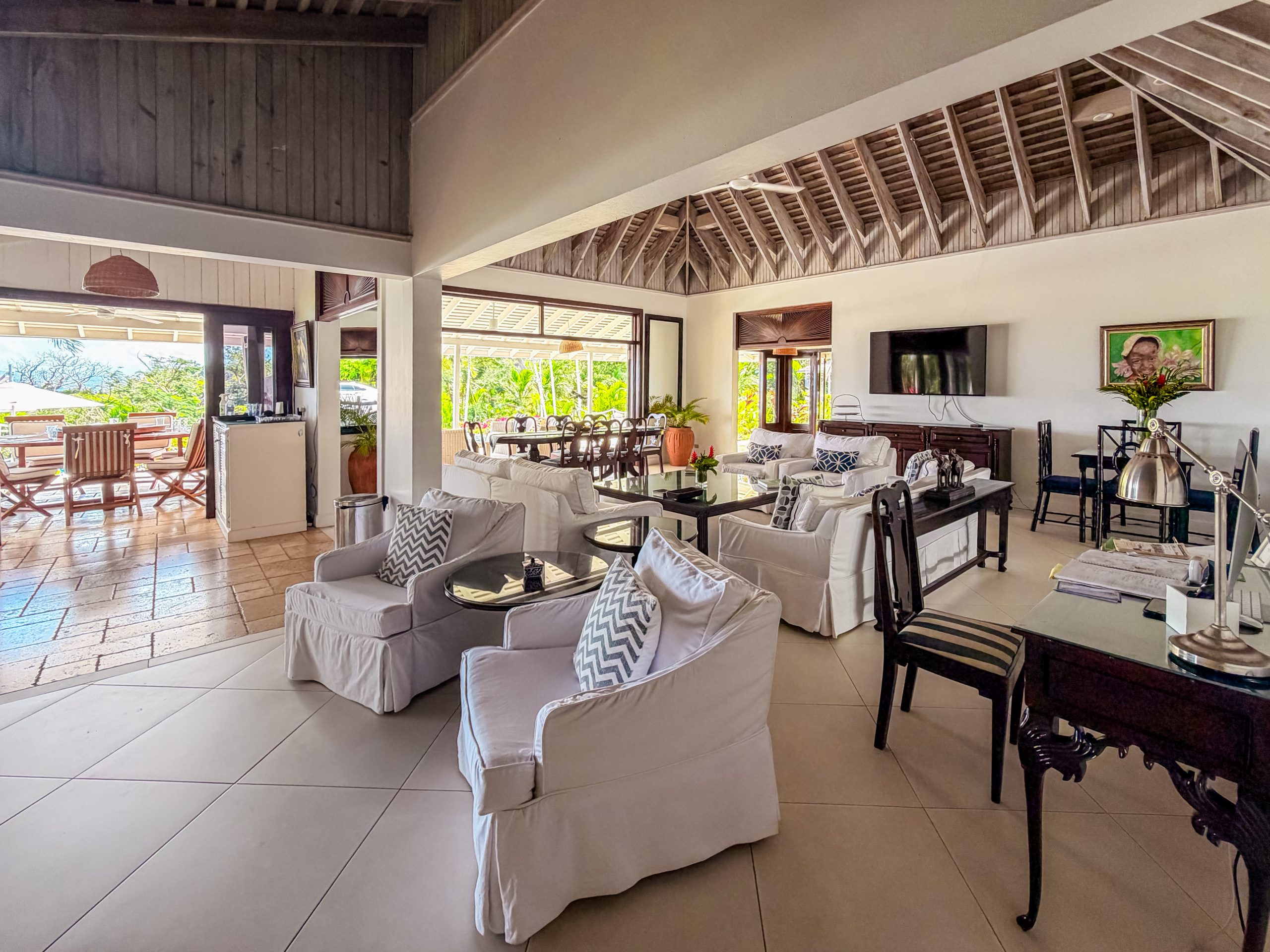 Open‑plan living and dining area at Coconut Cottage with comfortable seating, natural light and seamless indoor‑outdoor flow, creating a relaxed space for uninterrupted time together.